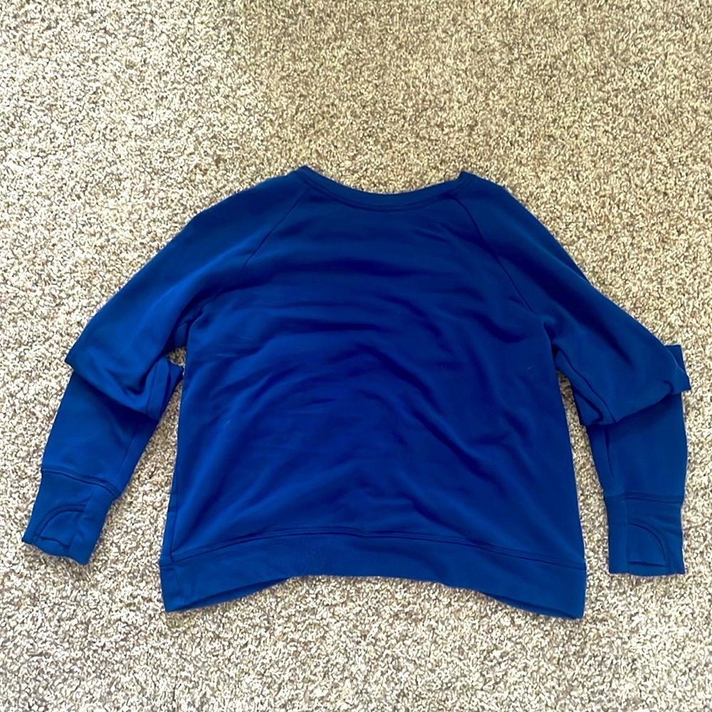 this is a long sleeve shirt, it is royal blue and has a cute slit in the back.